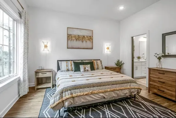 a bedroom with a bed and wooden floor