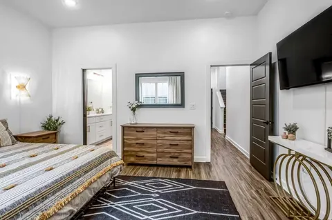 a room with two chair and a flat screen tv