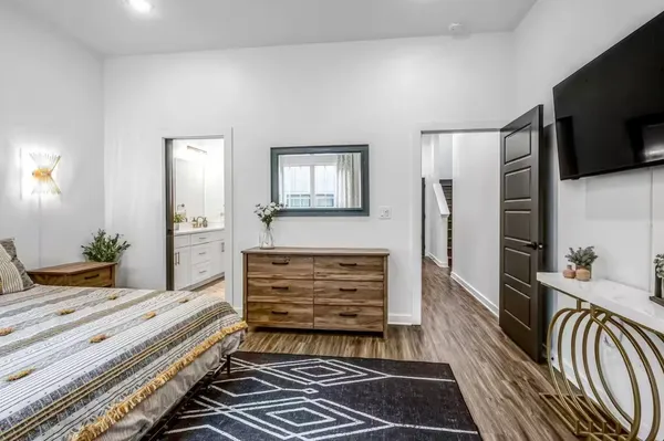a room with two chair and a flat screen tv