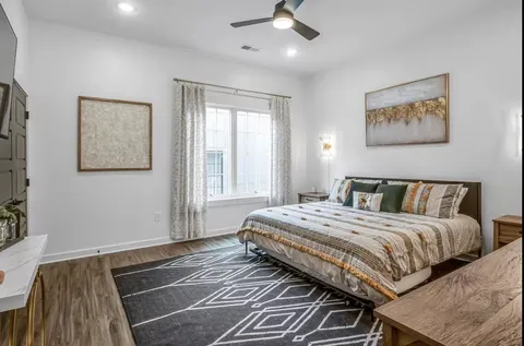 a bedroom with a bed and wooden floor