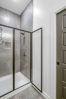 a bathroom with a glass shower door
