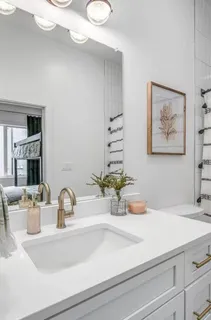 a bathroom with a sink a vanity and a mirror