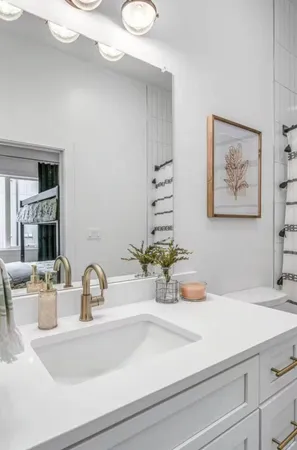 a bathroom with a sink a vanity and a mirror