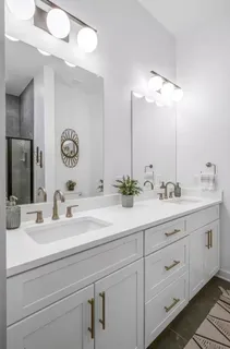 a bathroom with double sink and a mirror
