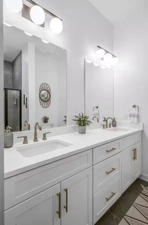 a bathroom with double sink and a mirror