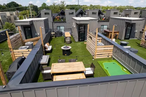 a outdoor room with chairs and a table