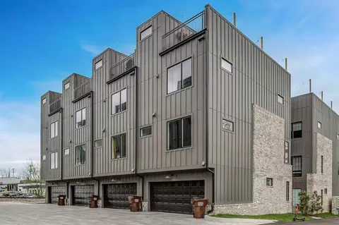 a view of a patio with couches and table and chairs and potted plants
