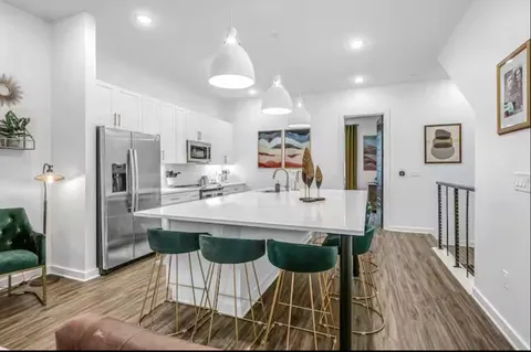a view of a dining room kitchen and a wooden floor