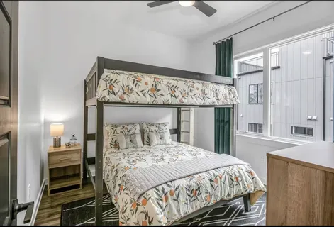 a bedroom with a large bed and a chandelier