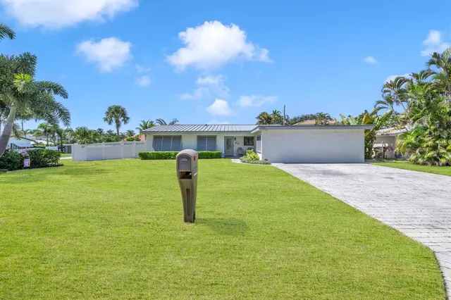 a house view with swimming pool and trees in the background