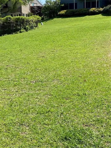 a view of a green yard with a house