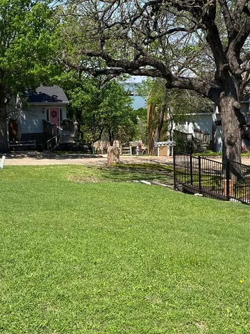 a view of house with backyard and a garden
