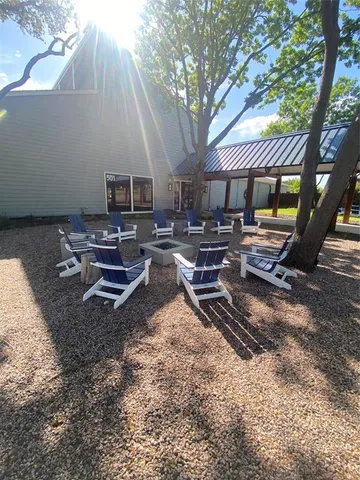 a backyard of a house with barbeque oven table and chairs