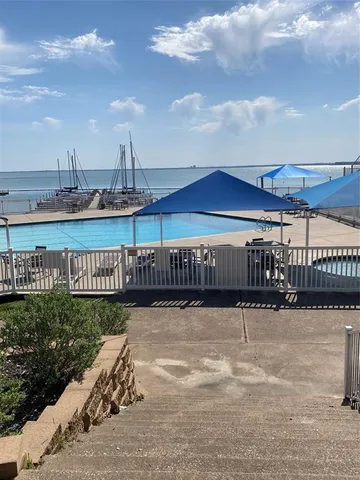 a view of a balcony with a floor to ceiling window and wooden fence