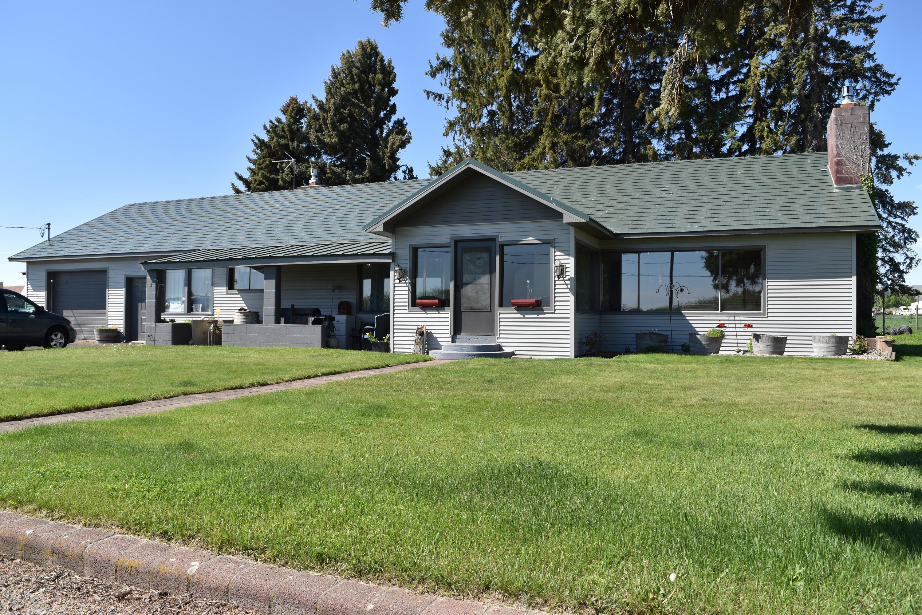 a front view of house with yard and green space