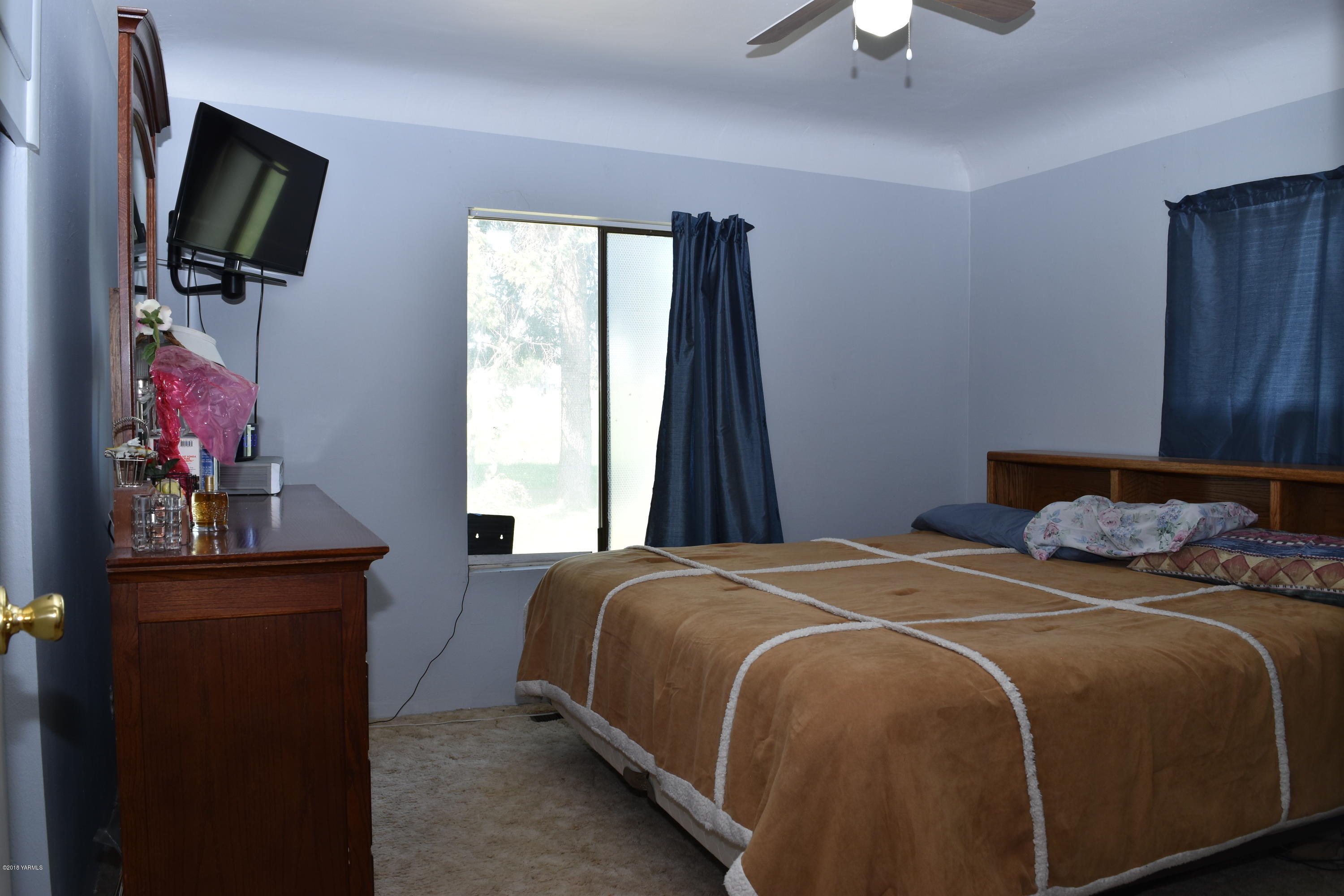 2000 Hiland Road Tieton, WA 98947 - Photo 10 of 16 a bedroom with a bed a flat screen tv and a window