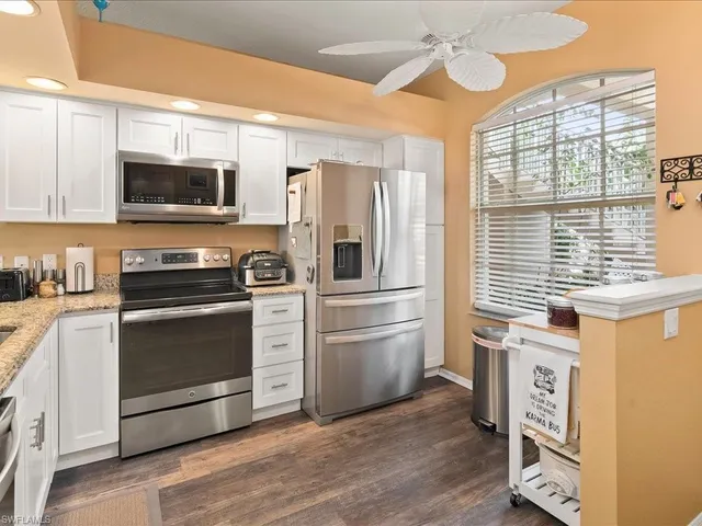 a kitchen with stainless steel appliances a stove microwave and a refrigerator