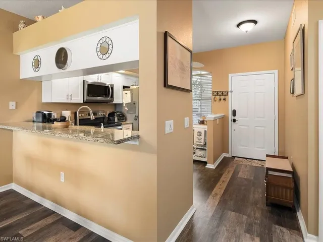 a kitchen with stainless steel appliances a refrigerator and a stove top oven