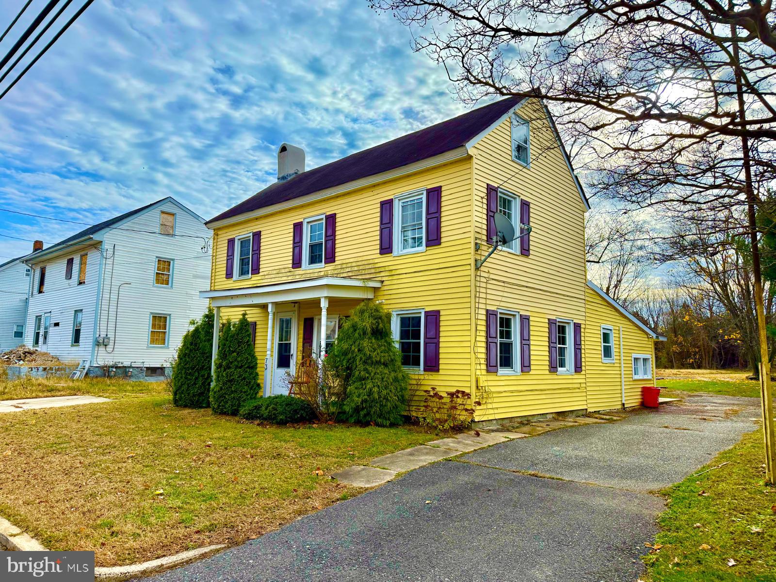 73 Maple Avenue Cedarville, NJ 08311 - Photo 3 of 25 a view of a white house with a large windows and yard