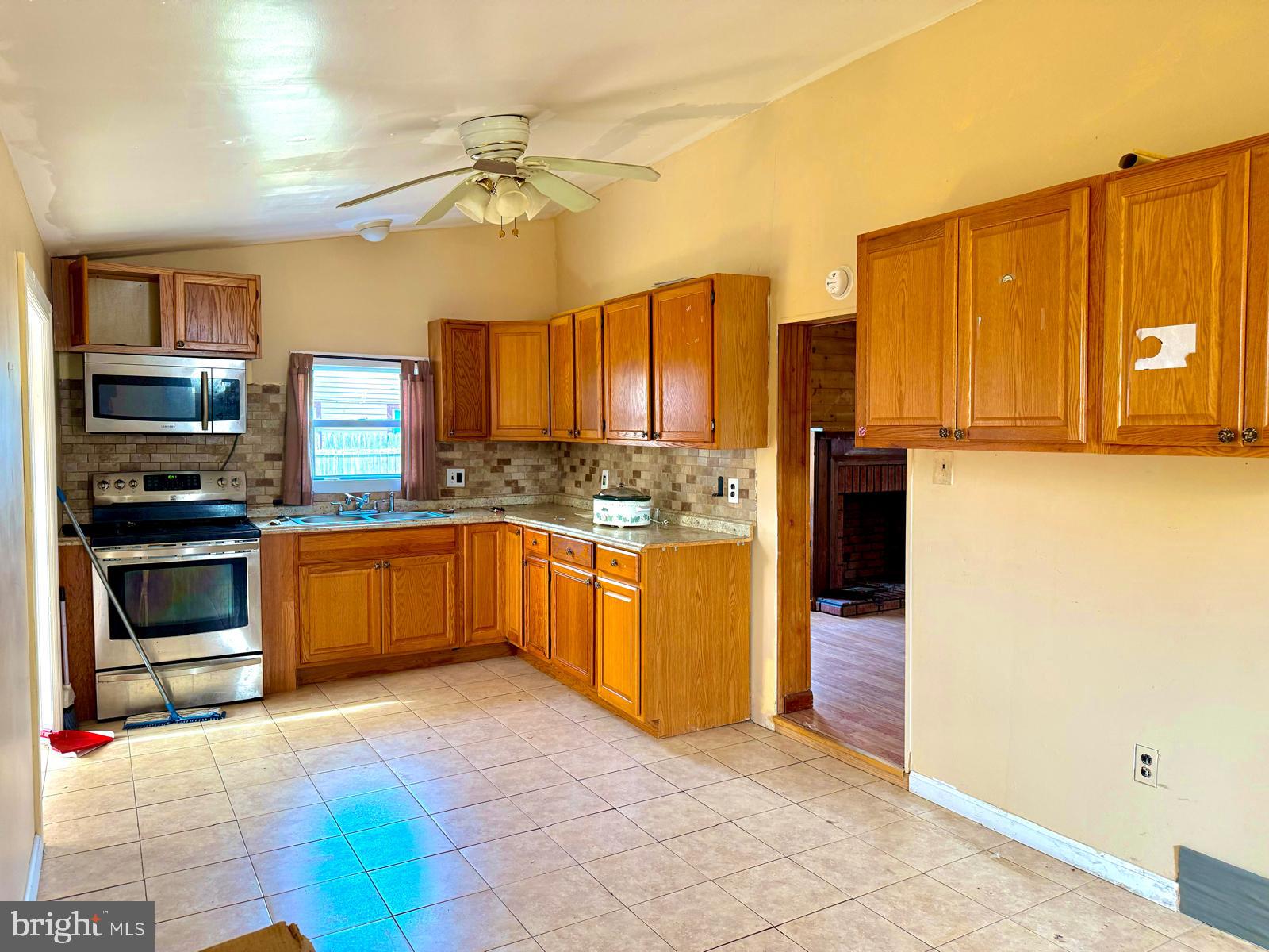 73 Maple Avenue Cedarville, NJ 08311 - Photo 6 of 25 a kitchen with stainless steel appliances a stove a refrigerator and a sink