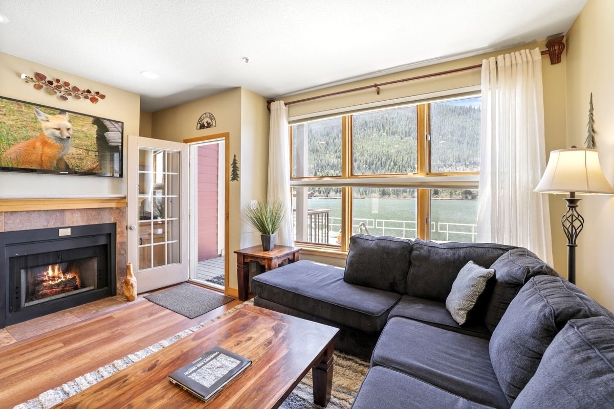 a living room with furniture a window and a fireplace