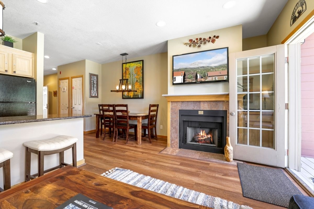 22138 Highway 6, Unit 1553 Keystone, CO 80435 - Photo 12 of 43 a living room with furniture a fireplace and a flat screen tv