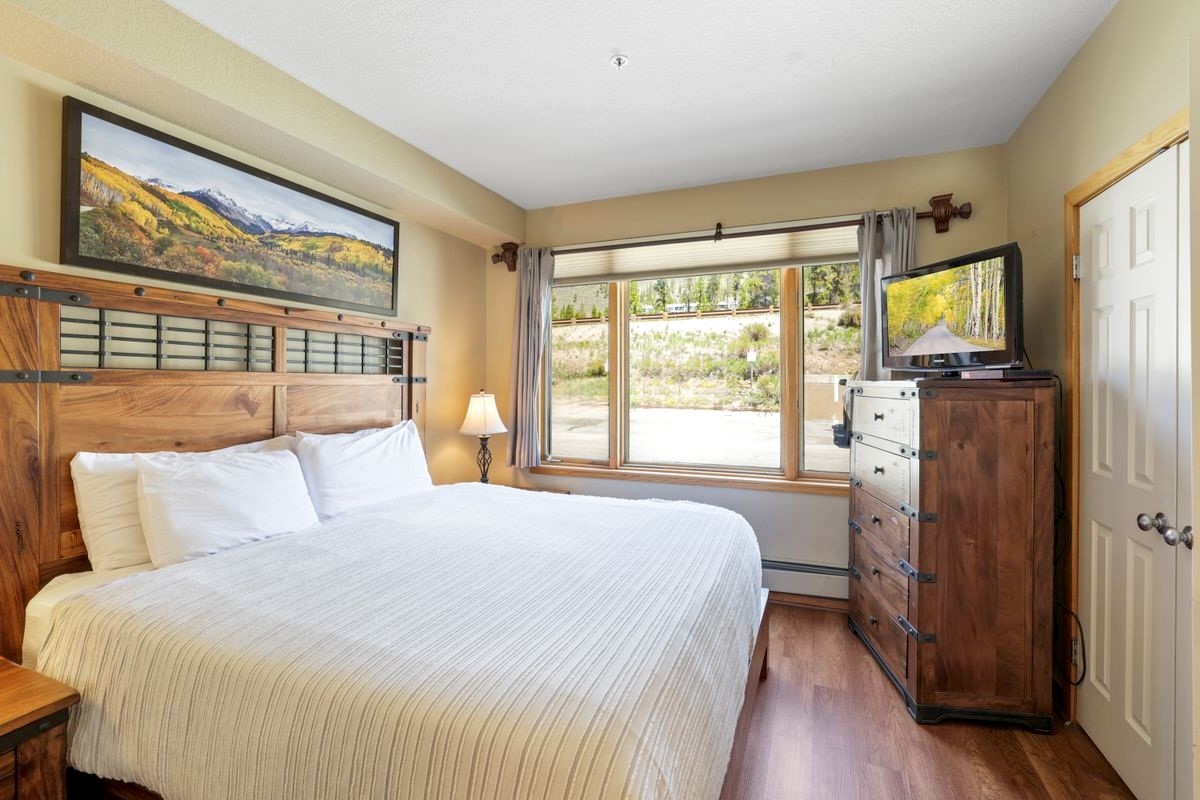 22138 Highway 6, Unit 1553 Keystone, CO 80435 - Photo 15 of 43 a bedroom with a bed and a large window