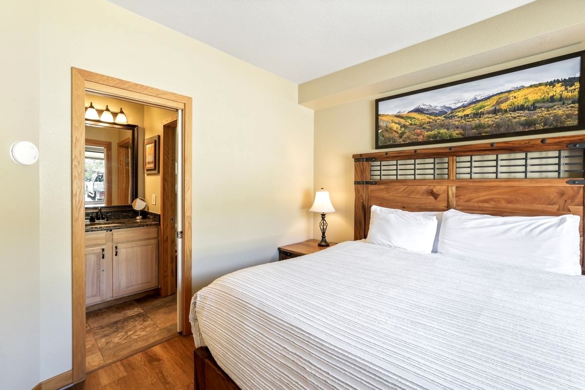 22138 Highway 6, Unit 1553 Keystone, CO 80435 - Photo 6 of 43 a bedroom with a large bed and a flat tv screen on dresser