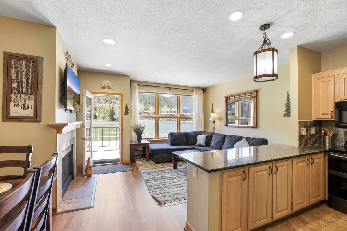 22138 Highway 6, Unit 1553 Keystone, CO 80435 - Photo 10 of 43 a living room with furniture large window and wooden floor