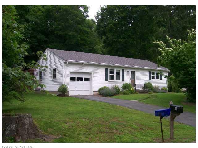 24 Maple Street Chester, CT 06412 - Photo 1 of 1 a front view of a house with a garden and yard