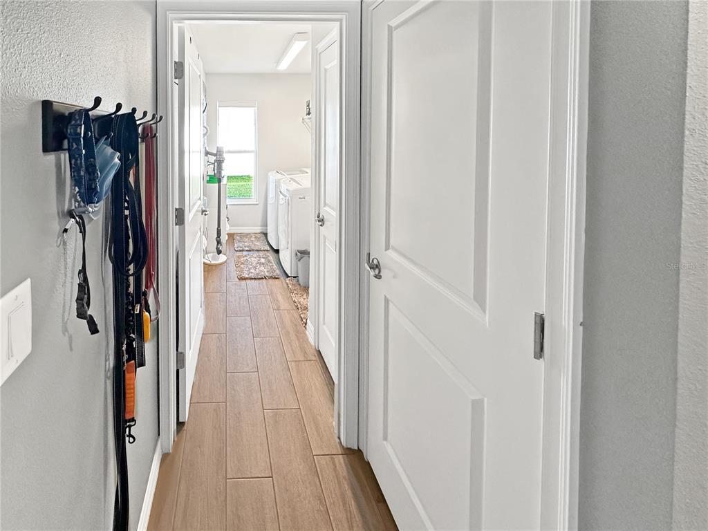 13023 Downy Woodpecker Road Weeki Wachee, FL 34614 - Photo 18 of 43 a view of a hallway with wooden floor and closet