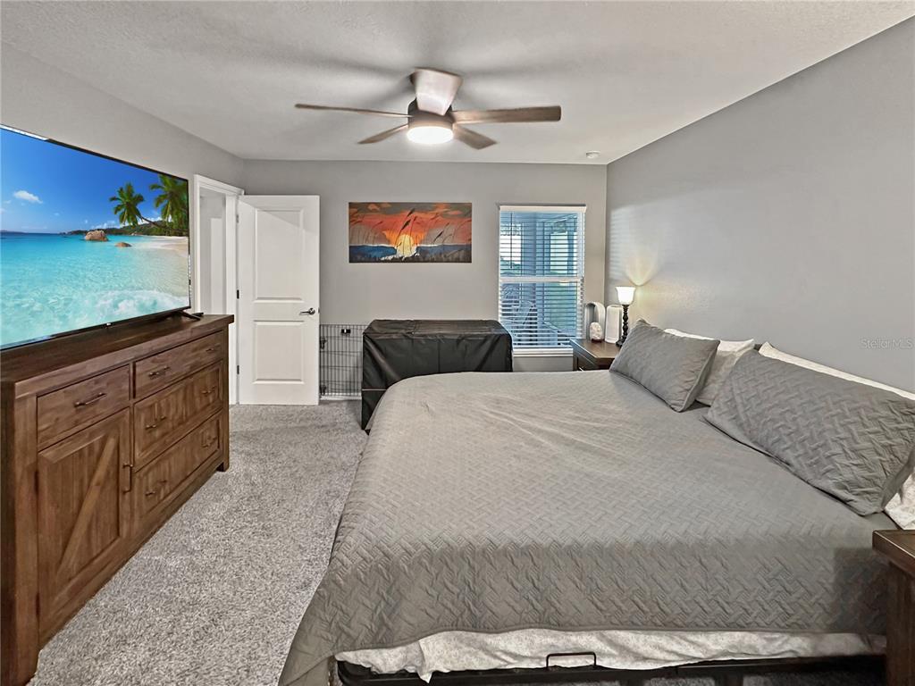 13023 Downy Woodpecker Road Weeki Wachee, FL 34614 - Photo 21 of 43 a bedroom with a bed and a flat screen tv