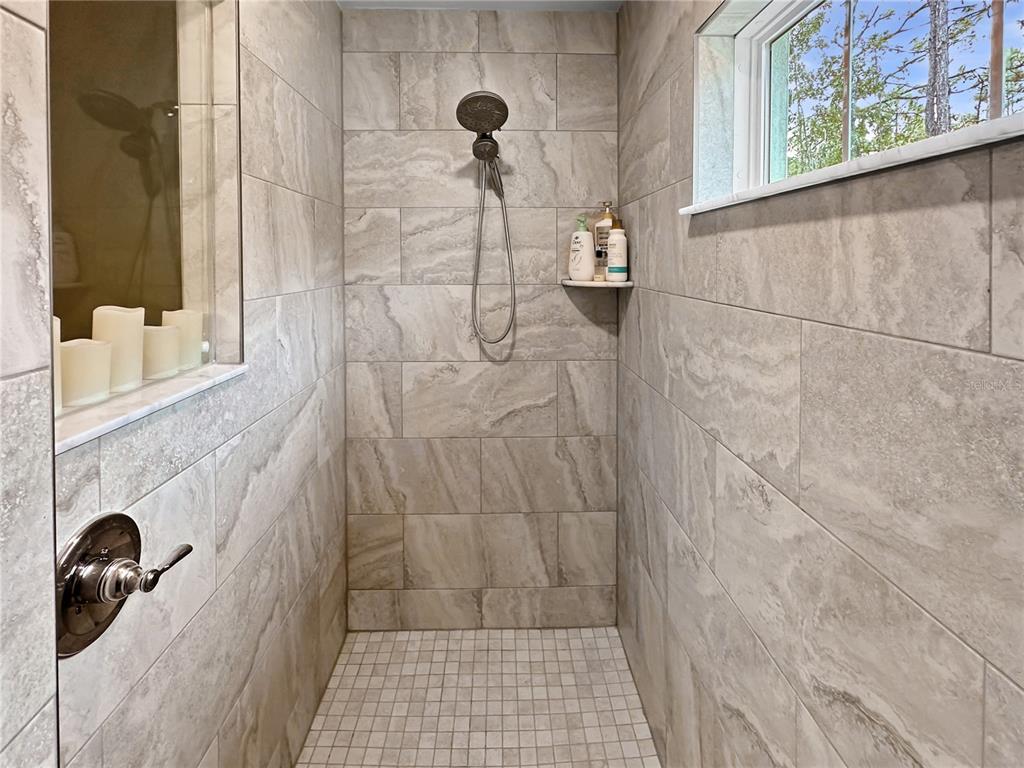 13023 Downy Woodpecker Road Weeki Wachee, FL 34614 - Photo 24 of 43 a bathroom with a shower