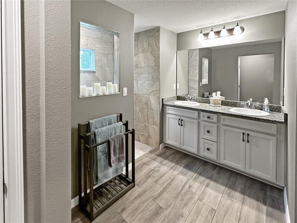 13023 Downy Woodpecker Road Weeki Wachee, FL 34614 - Photo 25 of 43 a view of a bathroom with dual sinks
