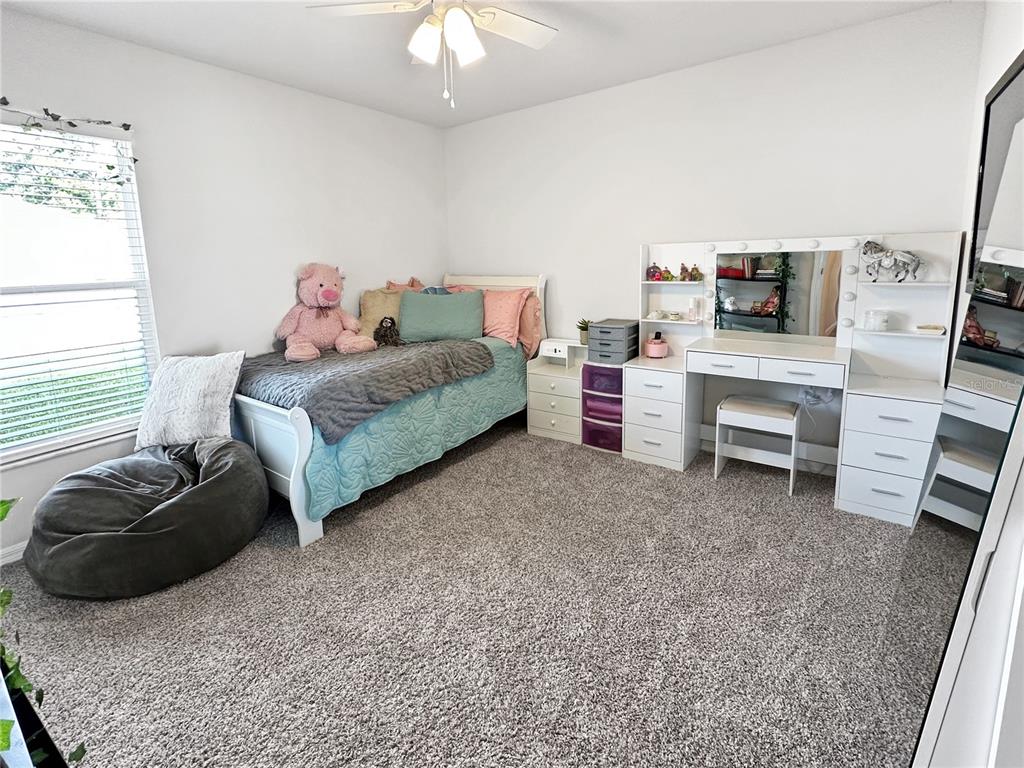 13023 Downy Woodpecker Road Weeki Wachee, FL 34614 - Photo 26 of 43 a bedroom with a bed and a couch