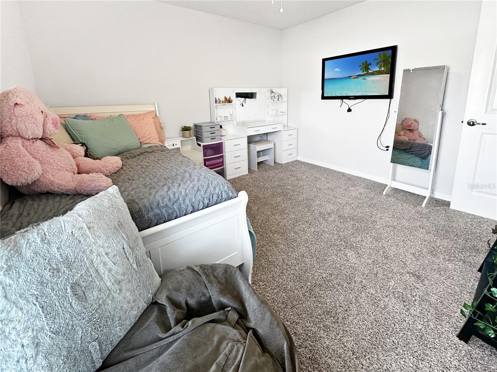 13023 Downy Woodpecker Road Weeki Wachee, FL 34614 - Photo 27 of 43 a living room with furniture and a flat screen tv