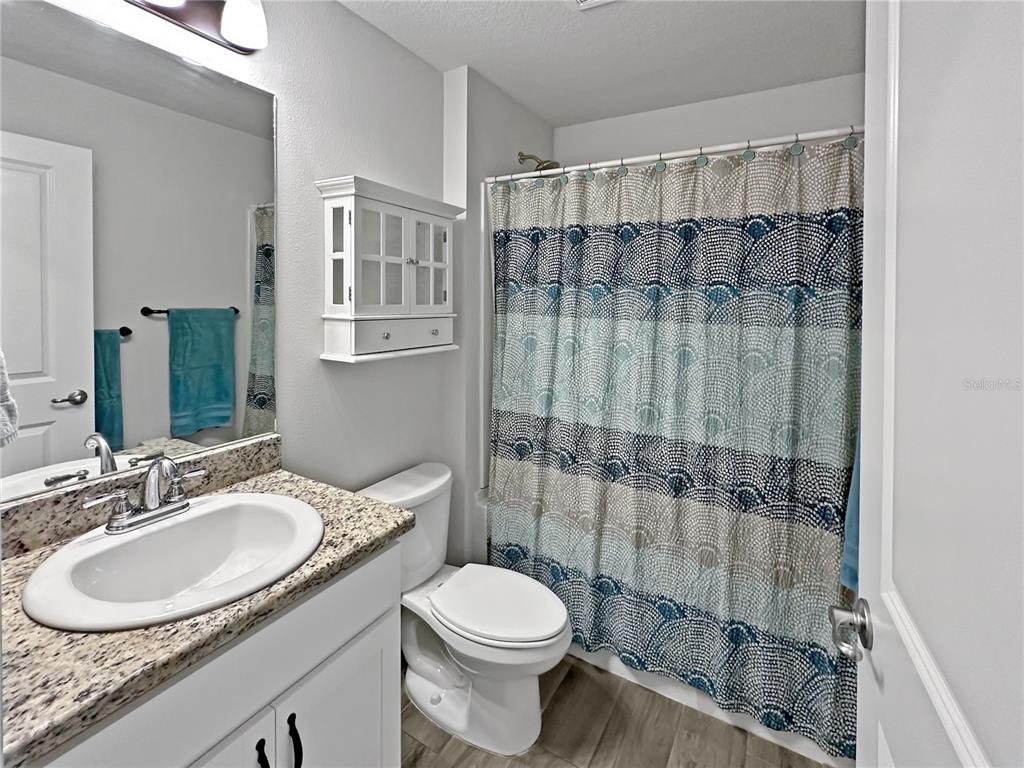 13023 Downy Woodpecker Road Weeki Wachee, FL 34614 - Photo 28 of 43 a bathroom with a sink toilet mirror and shower