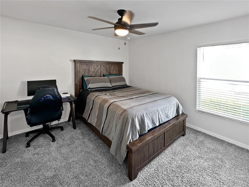 13023 Downy Woodpecker Road Weeki Wachee, FL 34614 - Photo 29 of 43 a bedroom with a bed chair and window