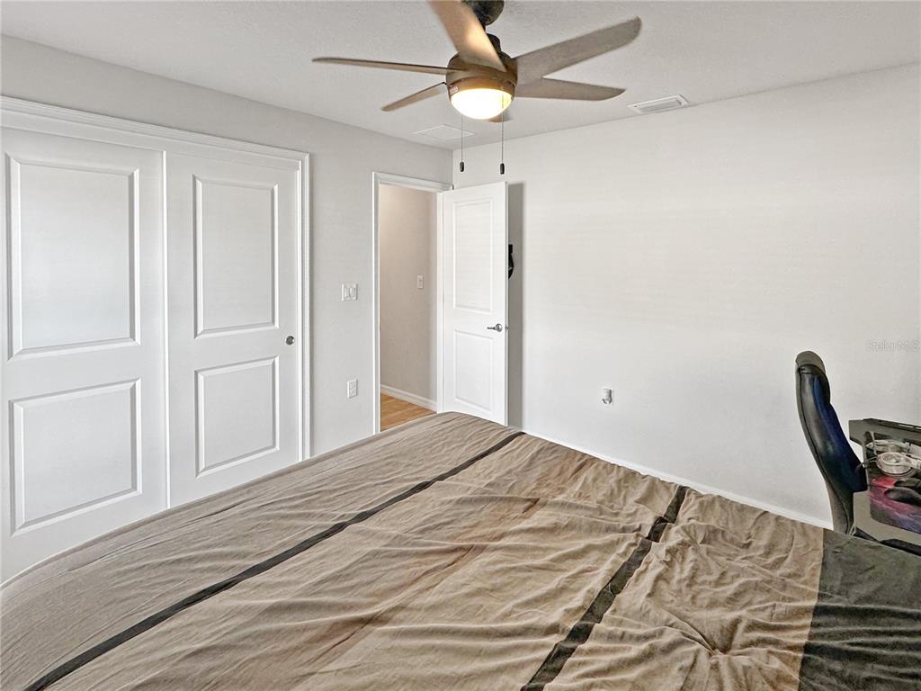 13023 Downy Woodpecker Road Weeki Wachee, FL 34614 - Photo 30 of 43 a bedroom with a bed and cabinets