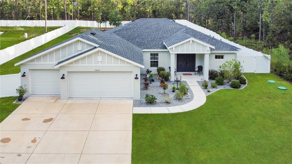 13023 Downy Woodpecker Road Weeki Wachee, FL 34614 - Photo 3 of 43 a house view with a garden space