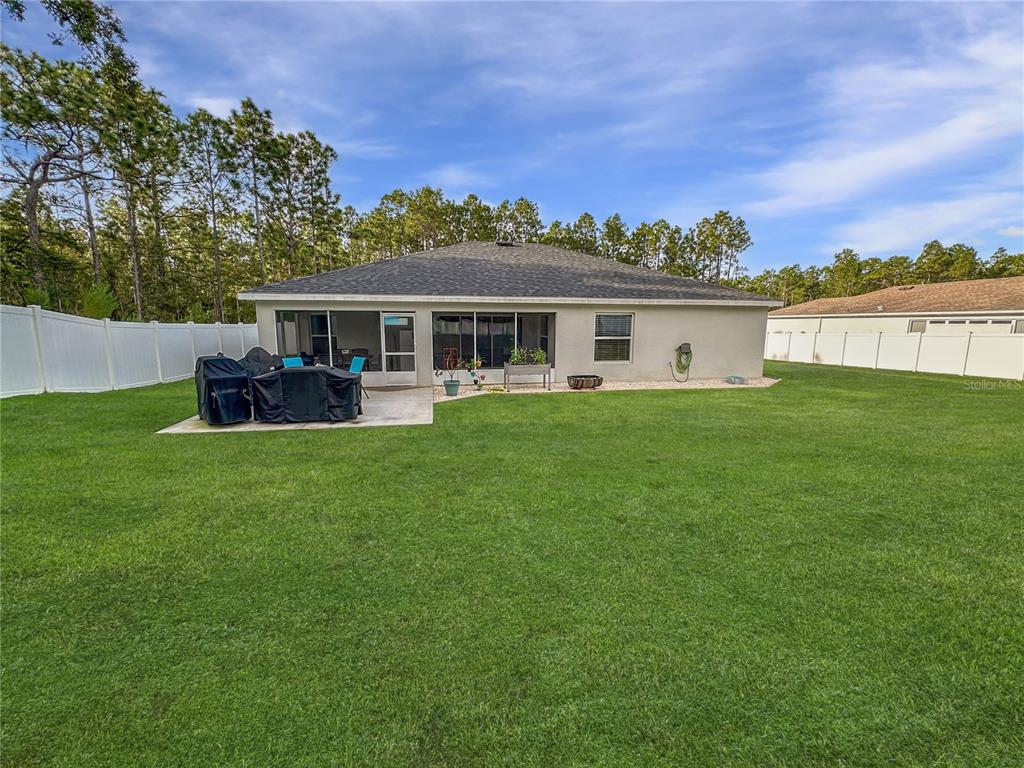 13023 Downy Woodpecker Road Weeki Wachee, FL 34614 - Photo 38 of 43 a view of a house with a backyard