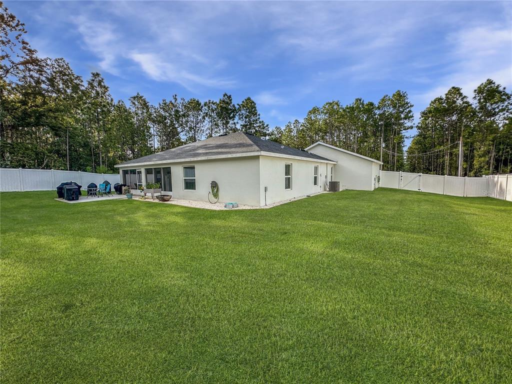 13023 Downy Woodpecker Road Weeki Wachee, FL 34614 - Photo 39 of 43 a view of a house with a yard and sitting area