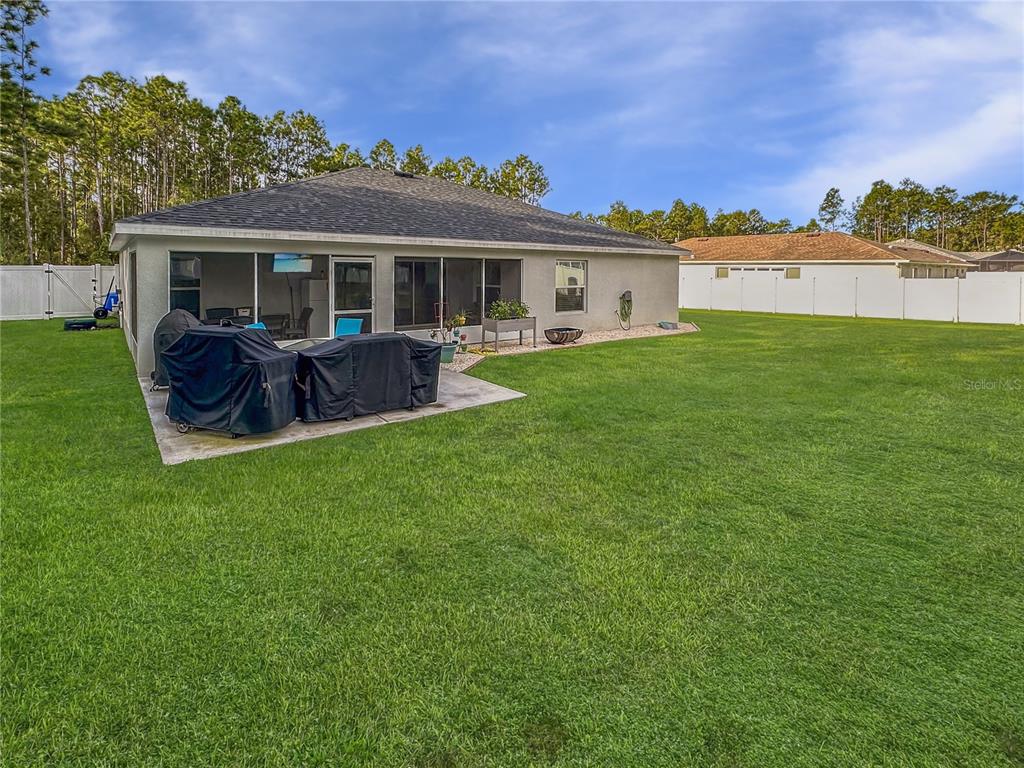 13023 Downy Woodpecker Road Weeki Wachee, FL 34614 - Photo 40 of 43 a view of a house with a yard and a patio