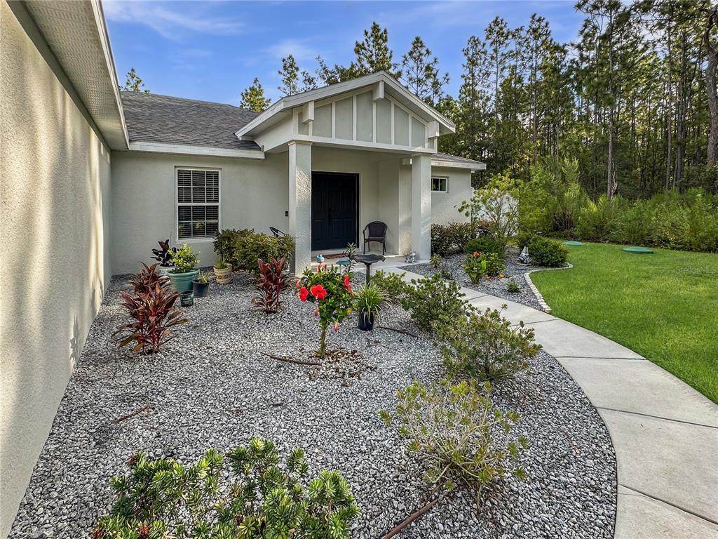 13023 Downy Woodpecker Road Weeki Wachee, FL 34614 - Photo 41 of 43 a front view of a house with garden