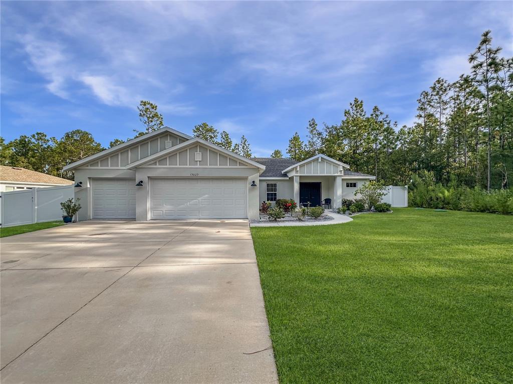 13023 Downy Woodpecker Road Weeki Wachee, FL 34614 - Photo 42 of 43 a front view of a house with a garden