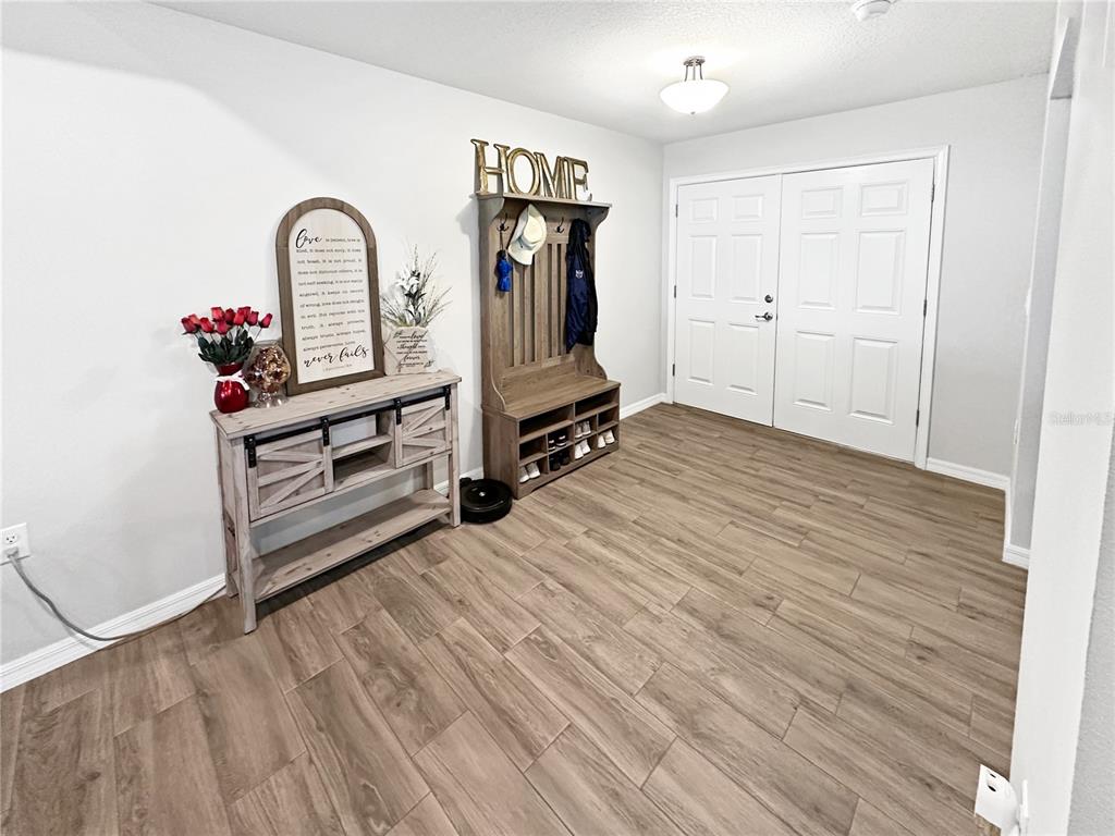 13023 Downy Woodpecker Road Weeki Wachee, FL 34614 - Photo 9 of 43 a view of an empty room with wooden floor and a window