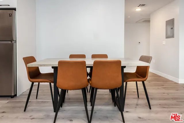 a dining room with furniture and wooden floor