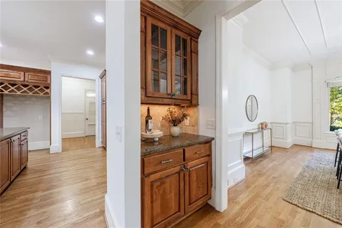 a view of a kitchen with a sink and dishwasher with wooden floor