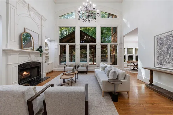 a living room with furniture fireplace and window