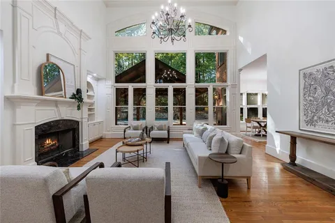 a living room with furniture fireplace and window
